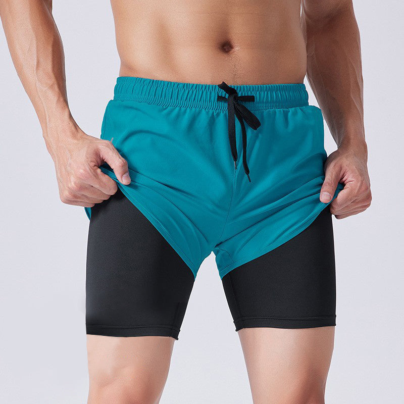 Teal and black shorts with a drawstring on a plain background